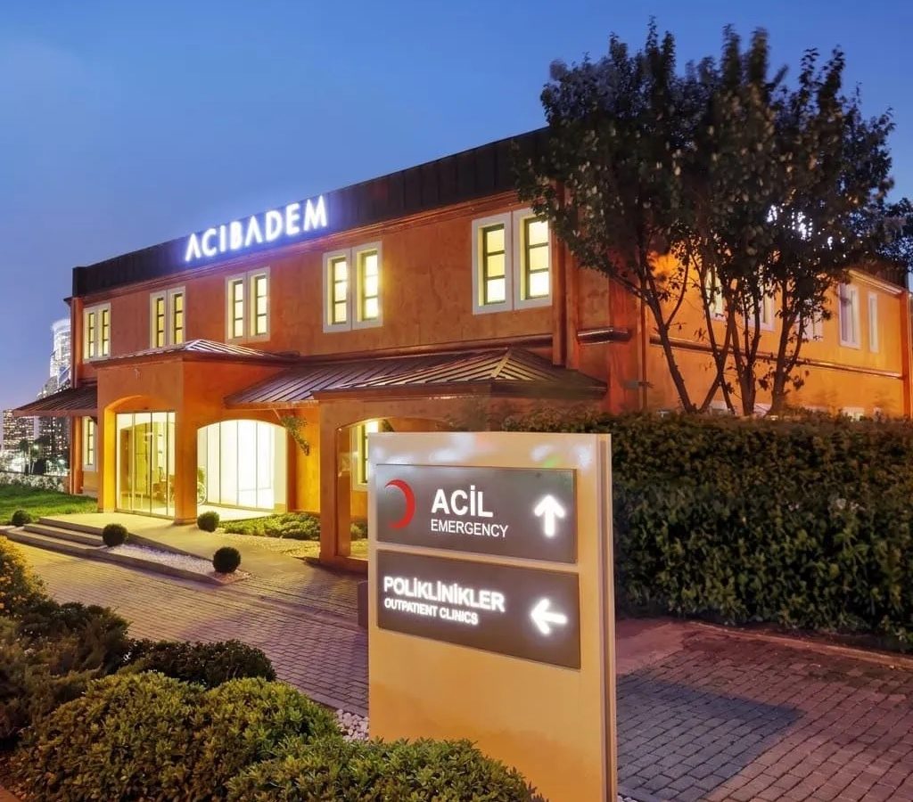 Exterior view of Acibadem Bahçeşehir Outpatient Clinic at dusk.