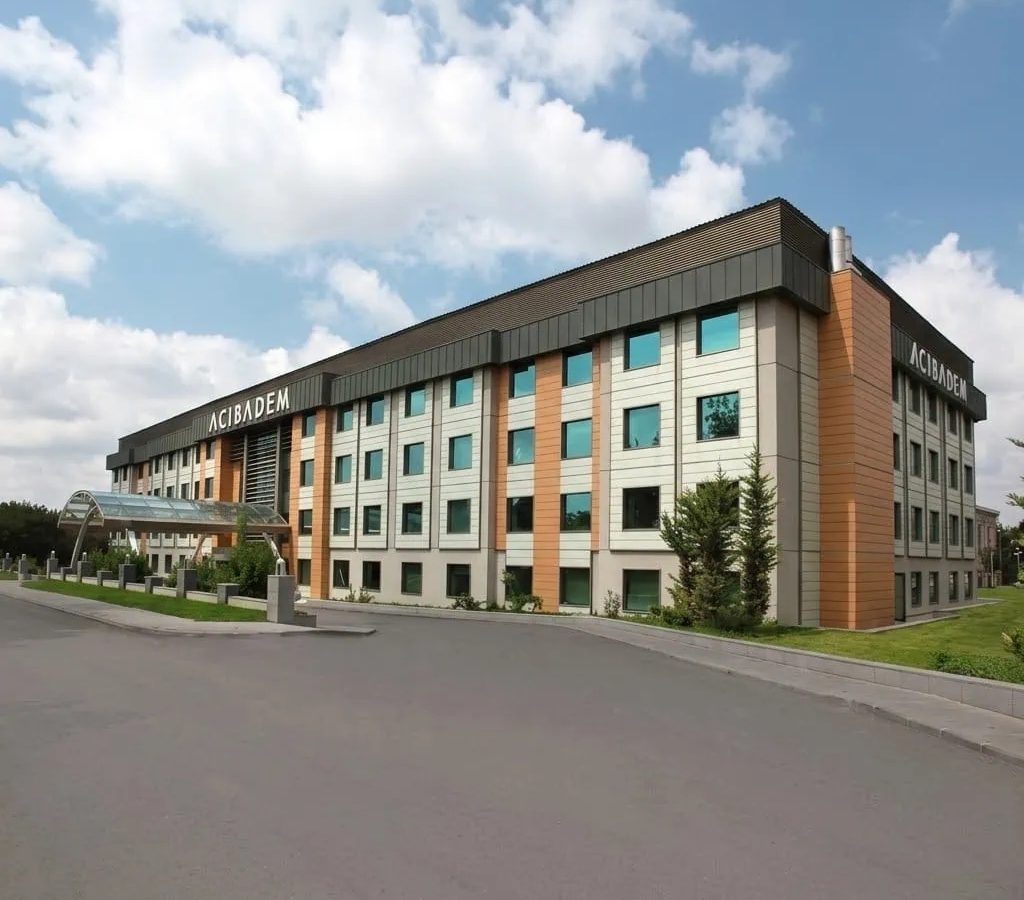 Modern hospital building with Acibadem signage in Kayseri, Turkey.