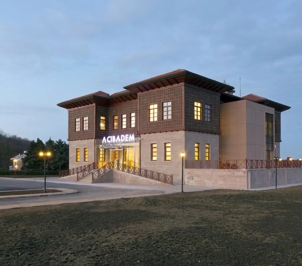 Exterior view of Acibadem Zekeriyaköy Outpatient Clinic building at dusk.